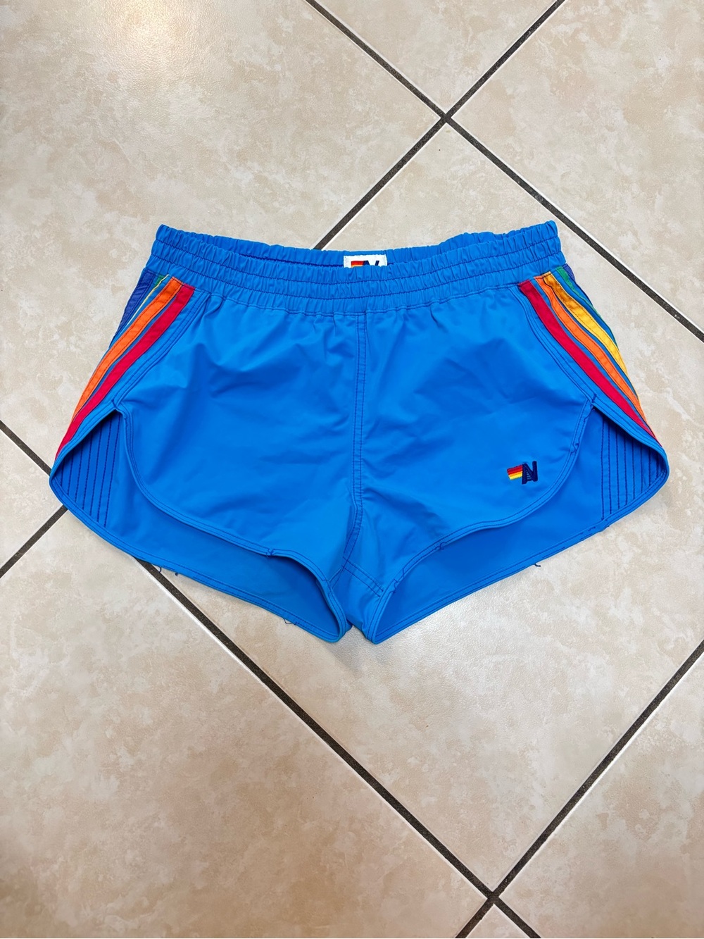 Aviator Nation blue board shorts with rainbow stripes on the sides, size XS